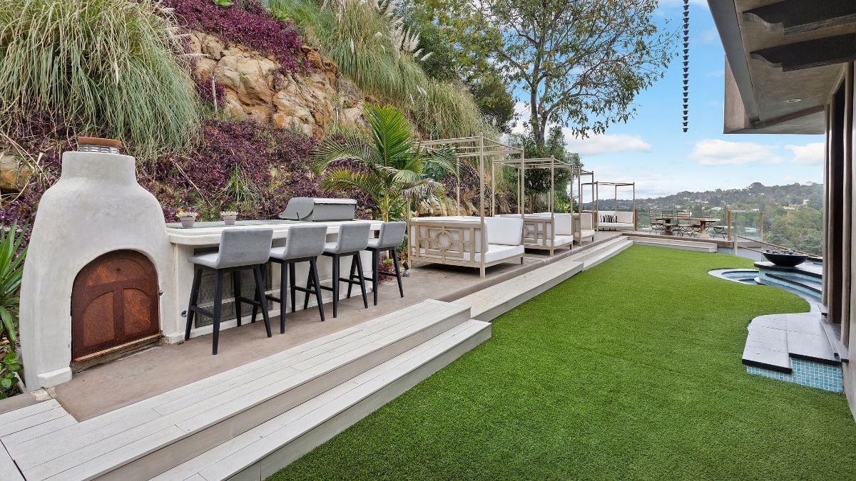Stepping outside the main level of the house to the zen backyard, which offers a multitude of attractive places for entertaining or hanging out in calm style, exemplifies the indoor outdoor lifestyle.