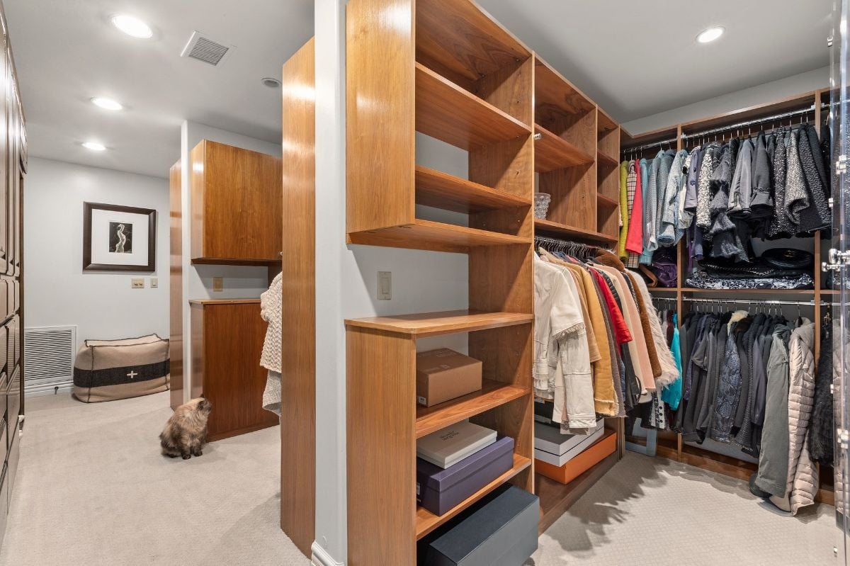 The master suite features a dresser with wooden shelves.