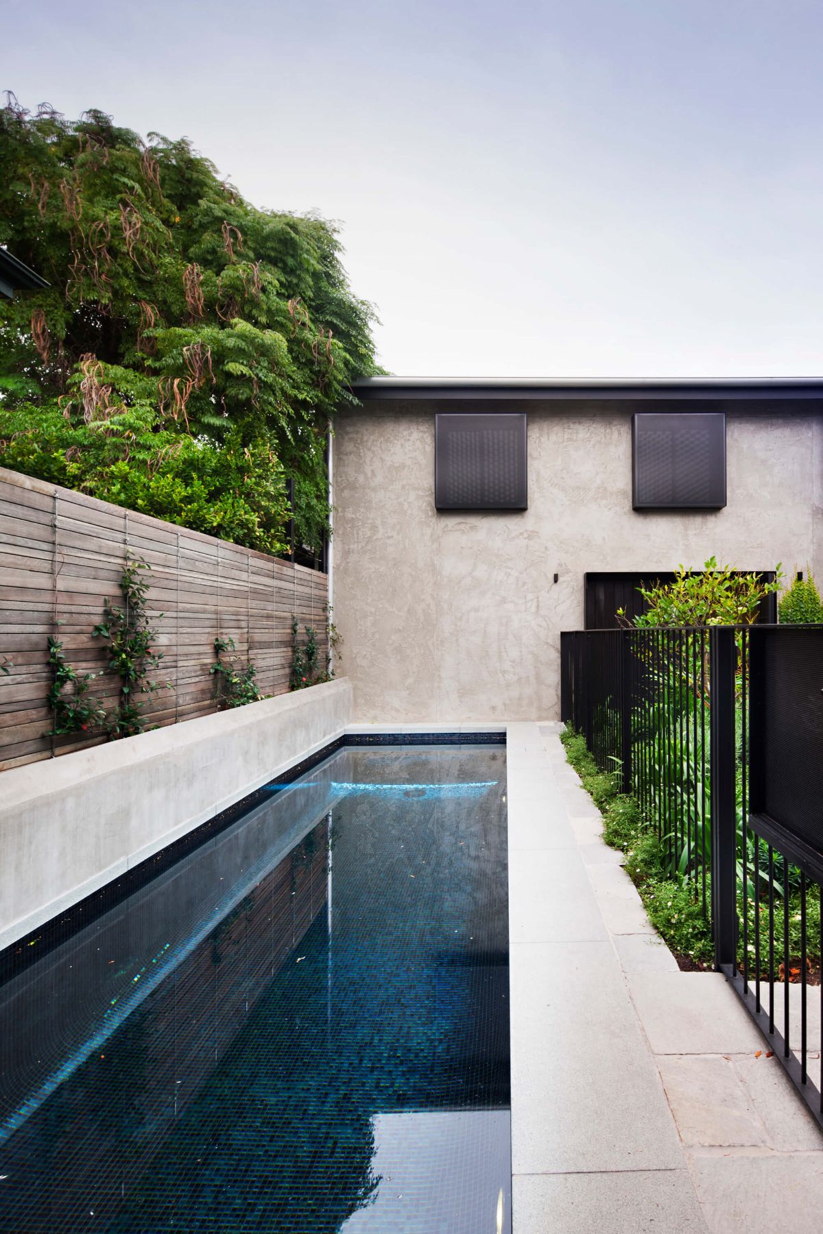 The house features a swimming pool with a metal fence.