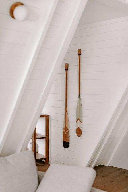 A picture showcasing a section of the living area, focusing on the two oars displayed on the wall.