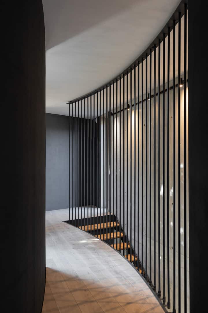 The staircase leads to the second-level loft framed with iron railings.
