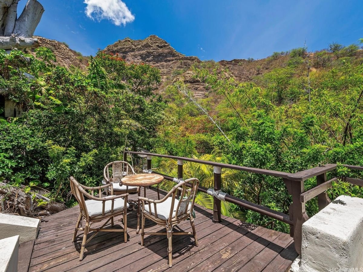 The backyard features an open dining area and a swimming pool for recreation.
