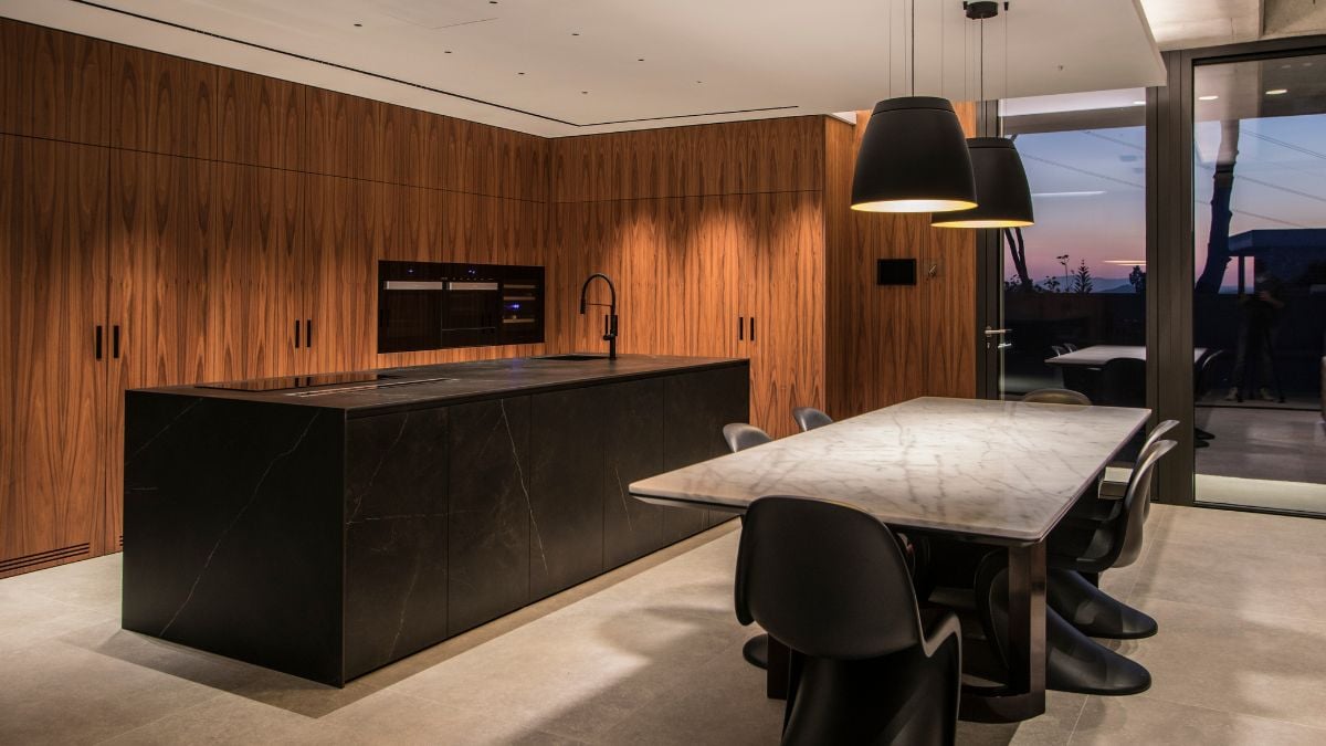 This image showcases the seamless integration of the dining and kitchen areas, creating a cohesive living space.