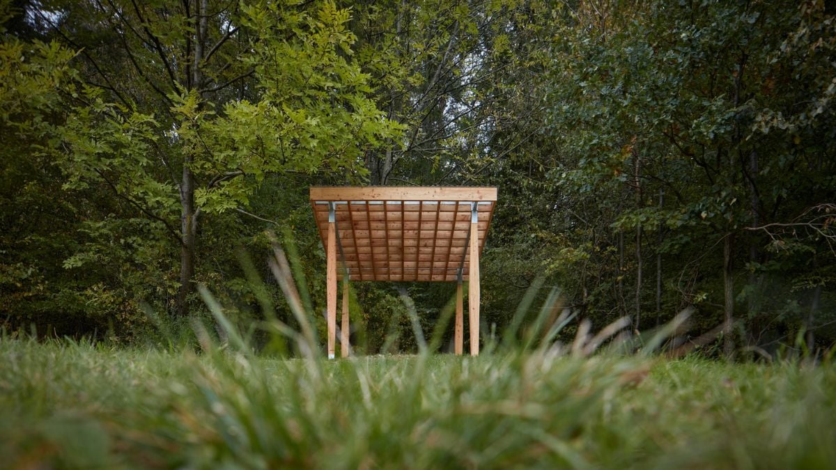 A low angle photo that highlights the roof of the Yogapoint structure, which is composed of a wooden grid with shading slats.