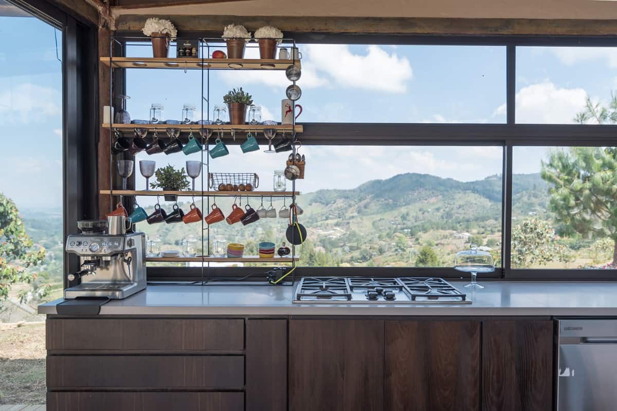 The kitchen's expansive windows frame the picturesque mountains.