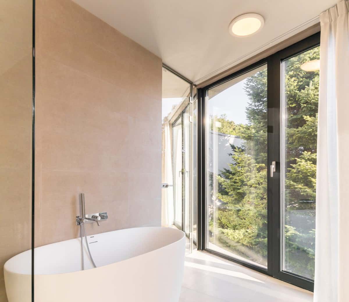 The bathroom is bright and airy. It has a deep soaking tub and direct access to the courtyard.