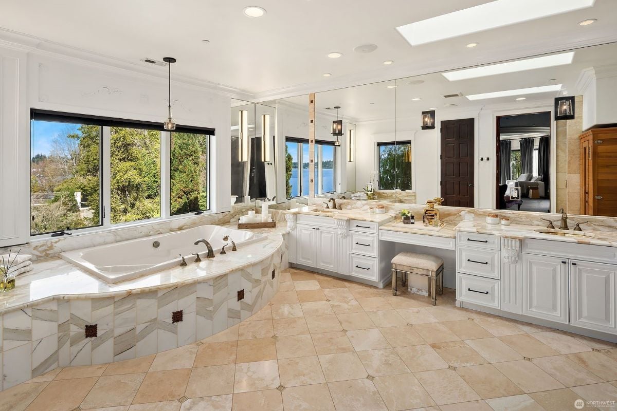The bathroom features a built-in bathtub and a vanity with a granite countertop.