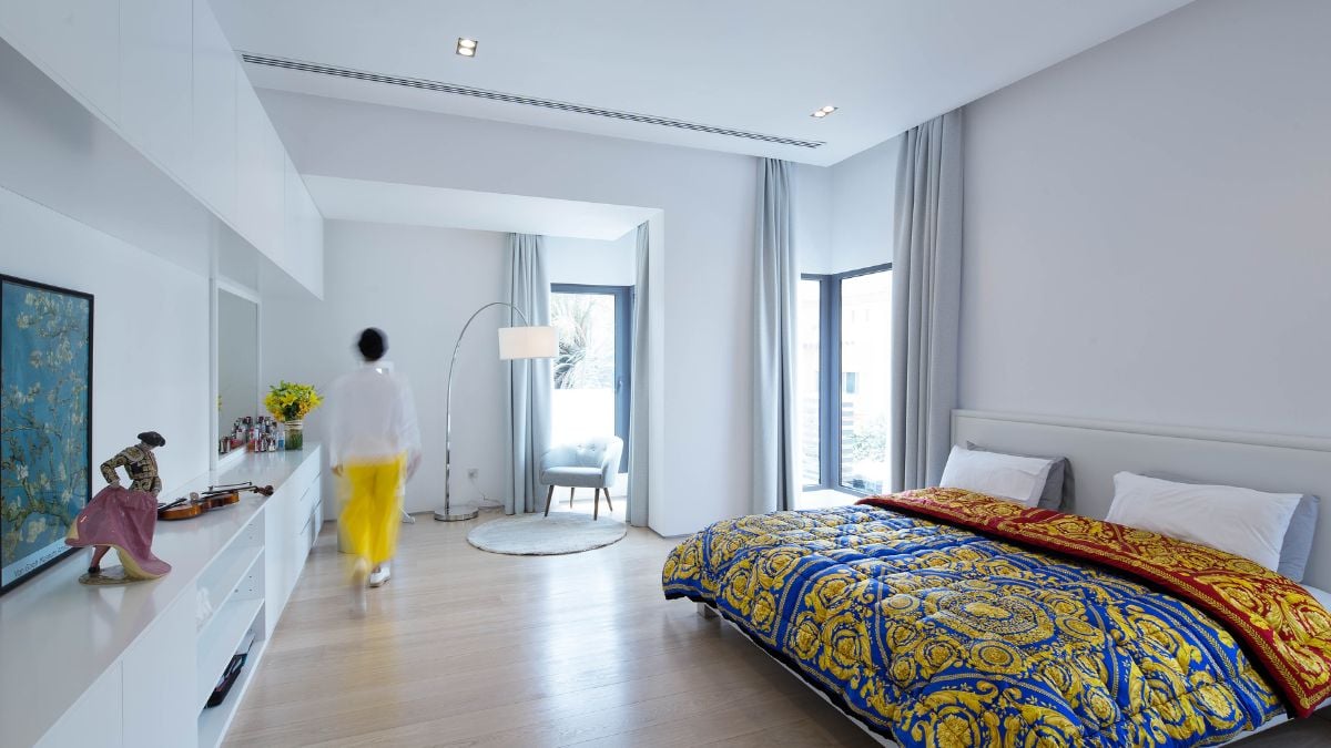 White spacious bedroom with full-height glass windows on corners.