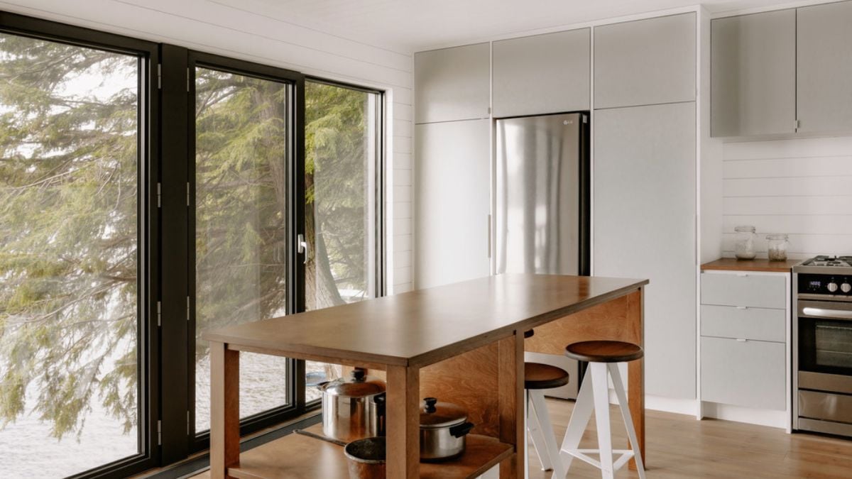 A photograph of the kitchen space within the house, highlighting a compact and straightforward dining set.