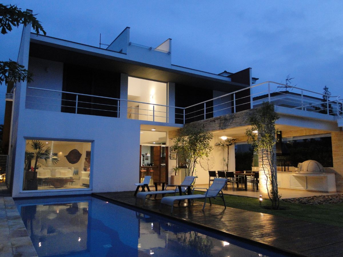The backyard of the house has a swimming pool and an open dining area.