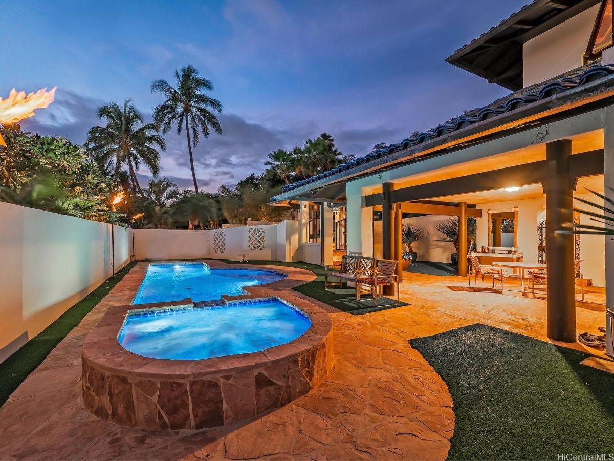 The swimming pool features a cocktail pool with a concrete deck.