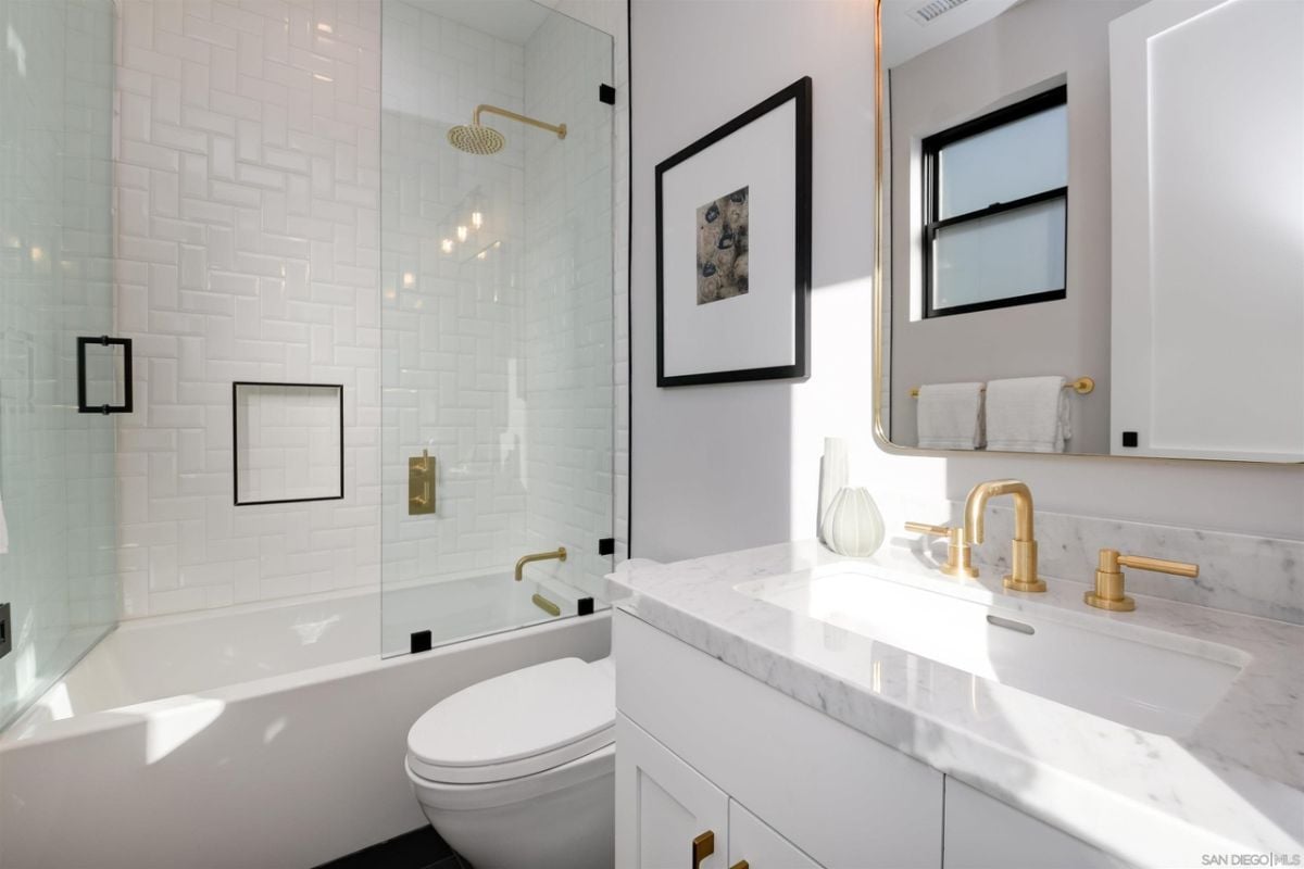 The bathroom features a built-in bathtub and a vanity with a tile countertop.