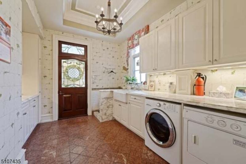 The house features a laundry room and a counter with granite tops.