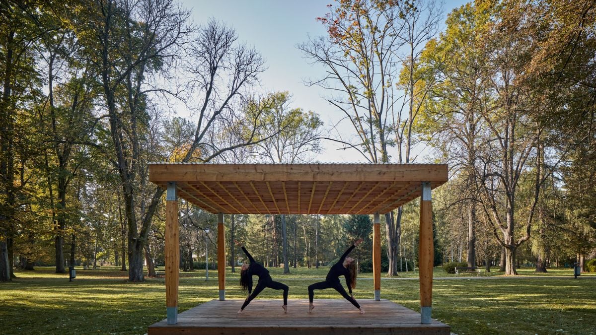 This photo offers a closer view of the larger Yogapoint structure, while also highlighting the lush green surroundings of the area with trees.