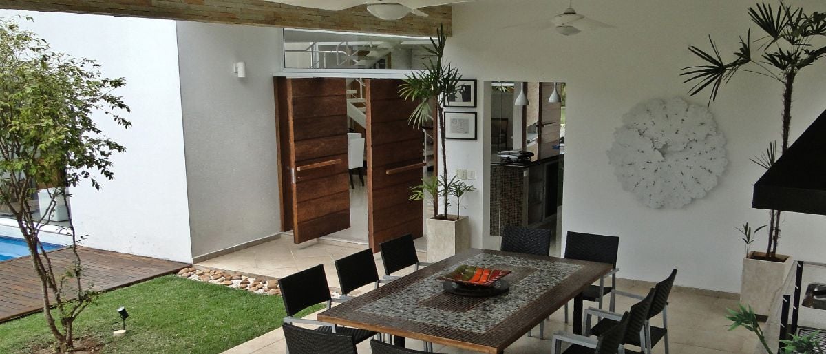 The covered patio features an open dining area good for outdoor relaxation.