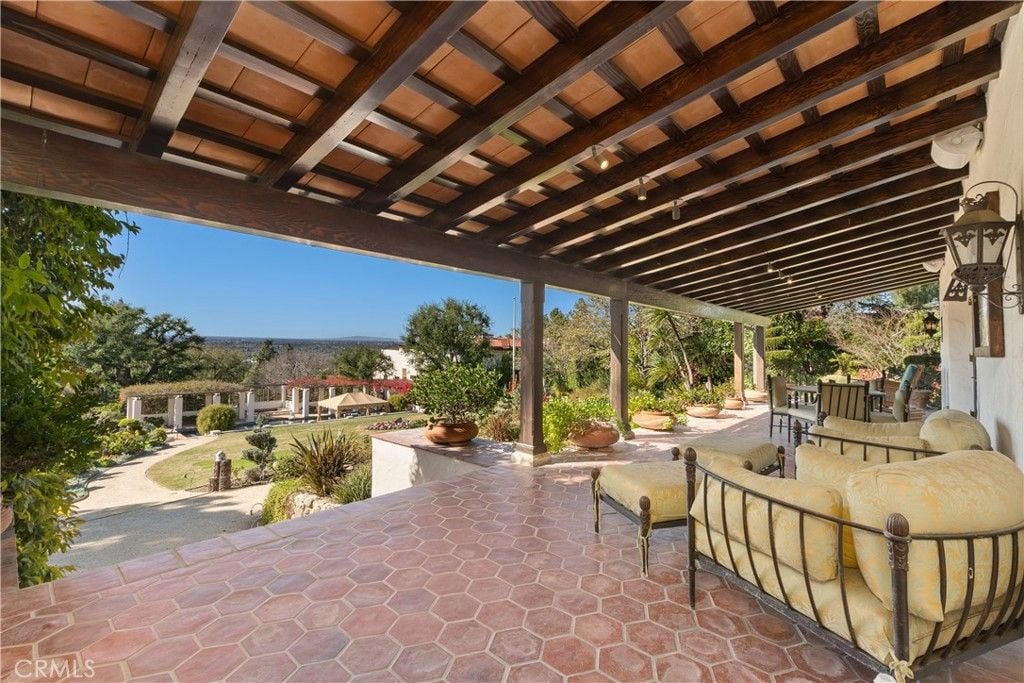 An outdoor dining table on the balcony showcases the view of the city.