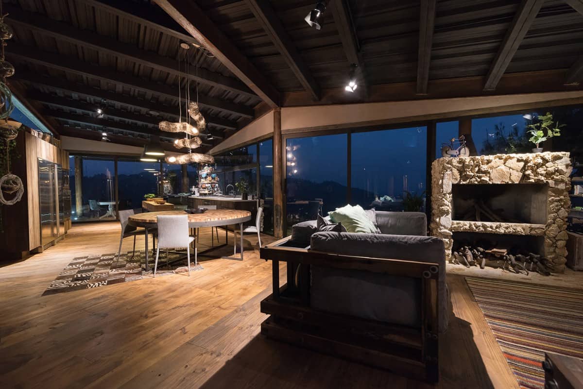 At night, the house is bathed in ambient lighting enhancing its cozy ambiance.