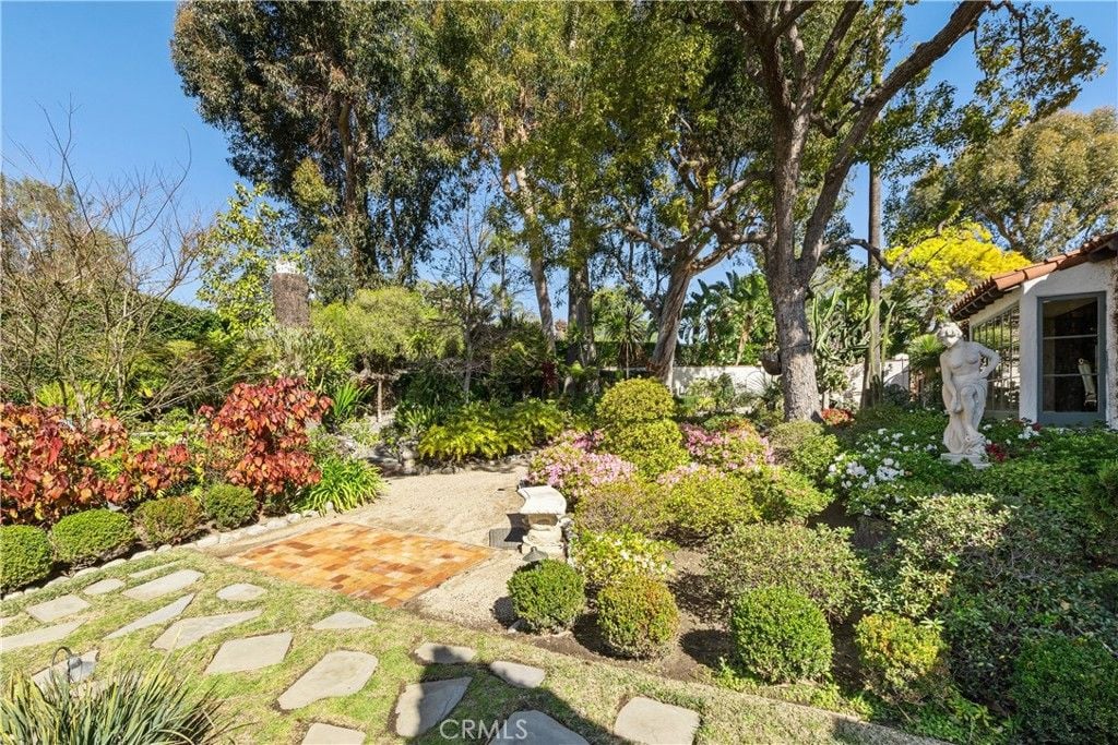 The garden is planted with beautiful flowers, and the statue adds luxury and color to the place.