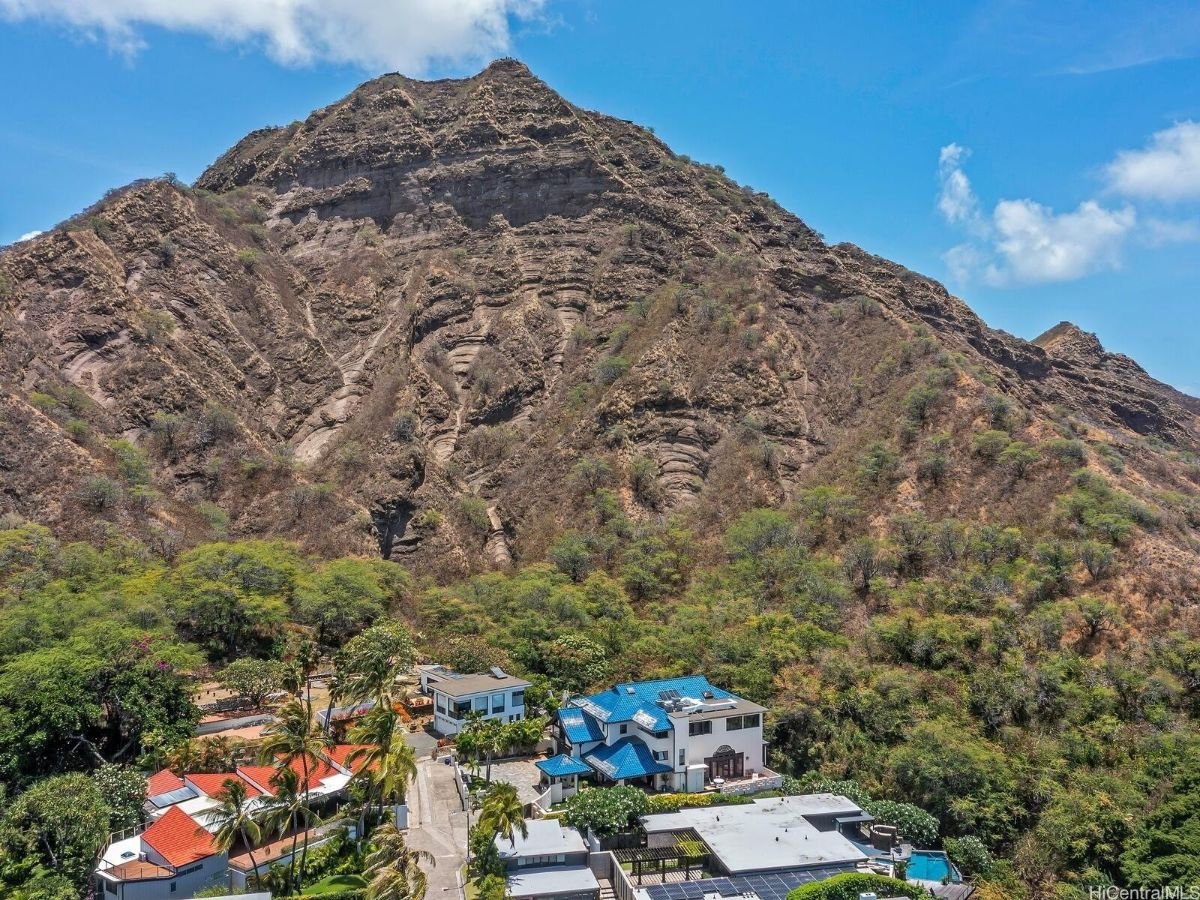 Aerial view of the house and the rocky mountain.
