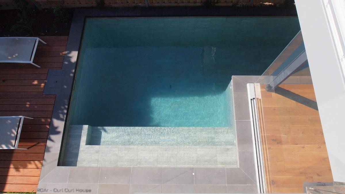 Top view of the pool complemented by a wooden deck.
