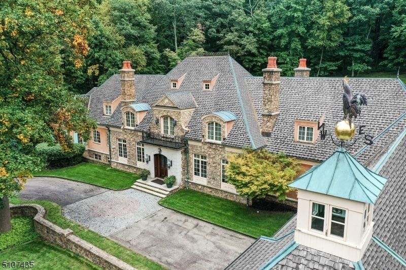 The exterior of the house has rough texture due to the stone wall, and the roof with asphalt shingles.