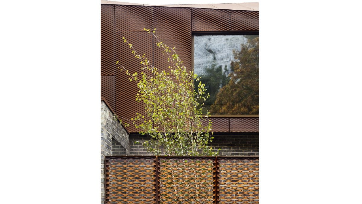 Glass and local ash-glazed brickwork are inset into an in-situ concrete frame at ground level, and walls and the roof are covered in a continuous skin of Cor Ten steel.