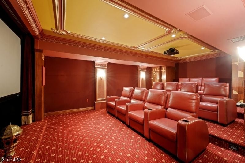 The home theatre was designed with red carpet and seating.