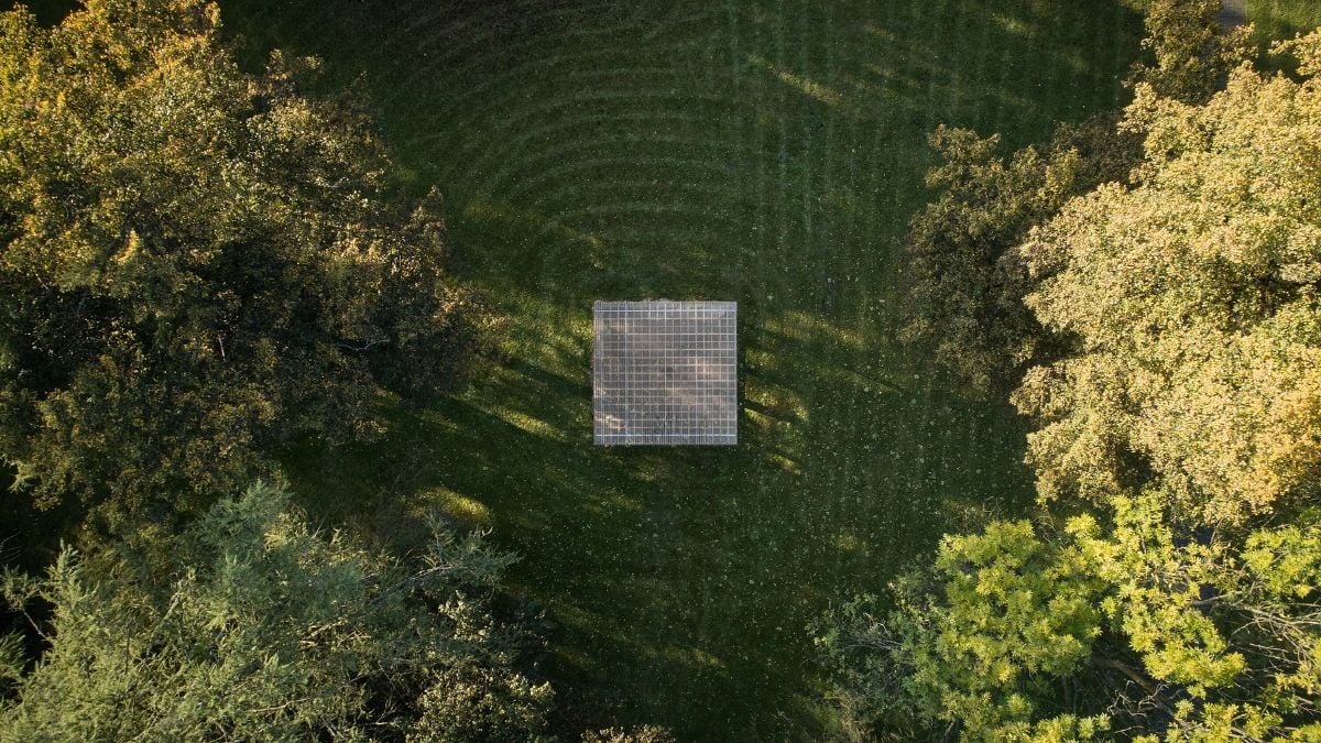 This photo offers an aerial view of the Yogapoint structure, while also highlighting the natural beauty of the lush greenery environment that surrounds it.