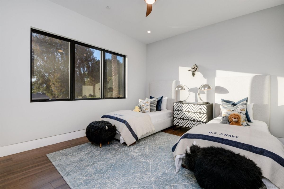 The kid's room features wooden flooring, and the carpet gives the room a cozy feel.