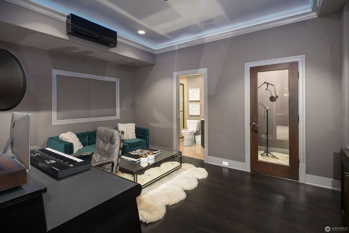 The music room features an organ, and the area rug gives off a cozy feel to the room.
