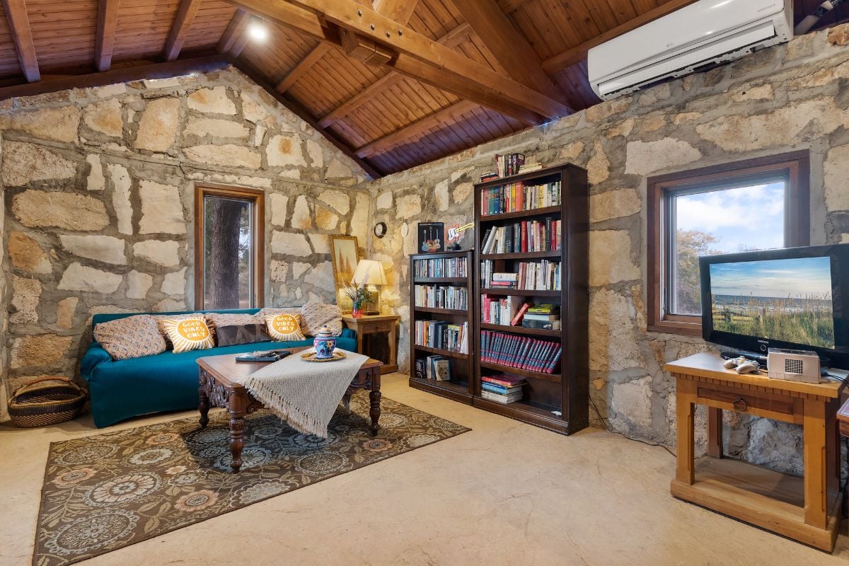 The guest house living area features a sofa and coffee table, giving the guest a comfortable experience.