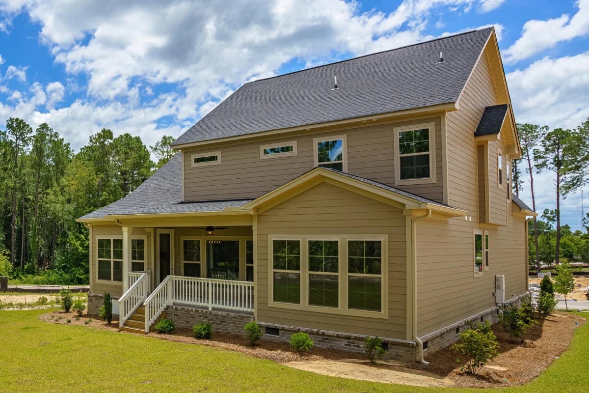 Rear-left exterior view with lots of white framed windows bringing an abundance of natural light in.