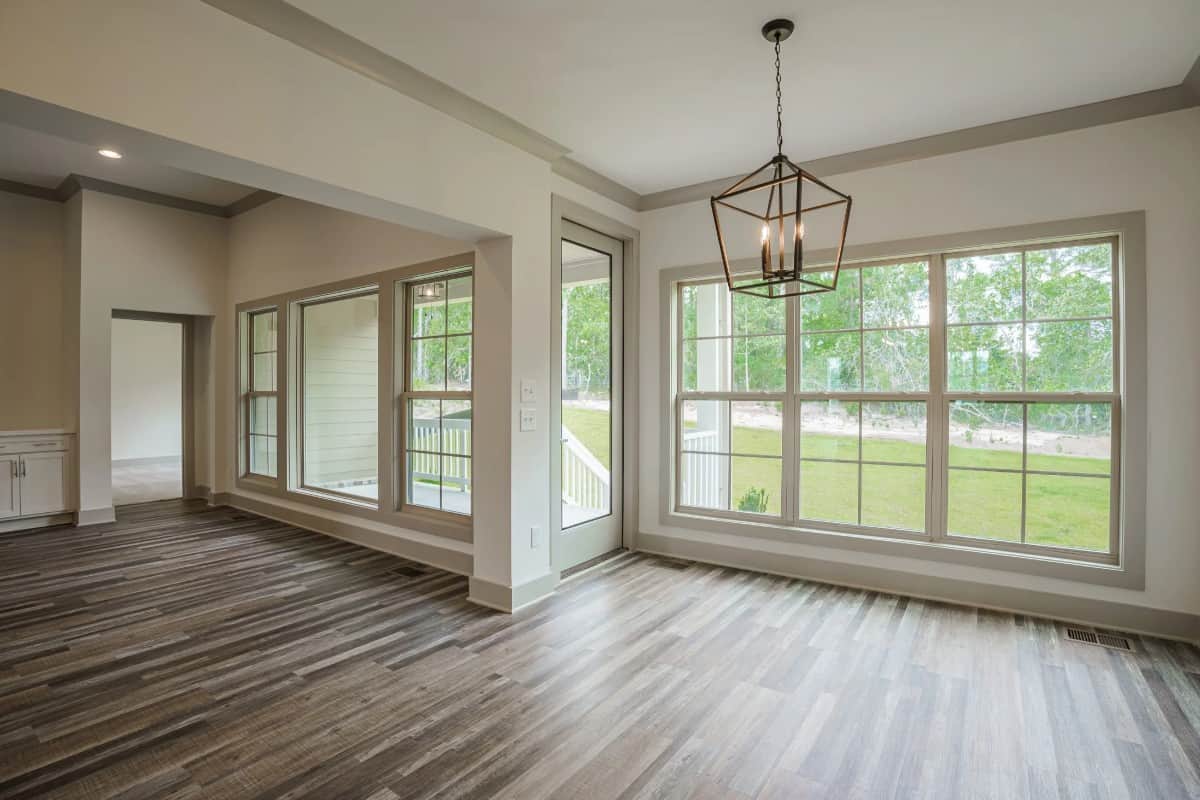 The keeping room includes a large pendant light and direct access to the covered porch via a glazed door.