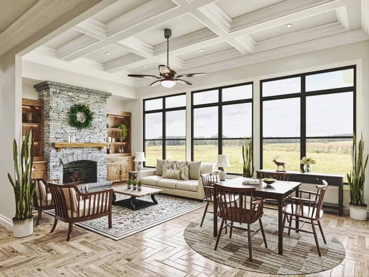 Keeping room with a coffered ceiling, a stone fireplace, and a breakfast area.