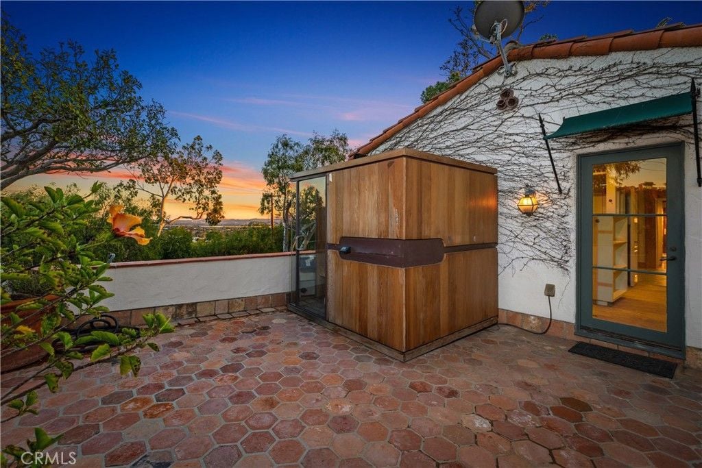 The patio features tile flooring, and the plant adds color to the place.