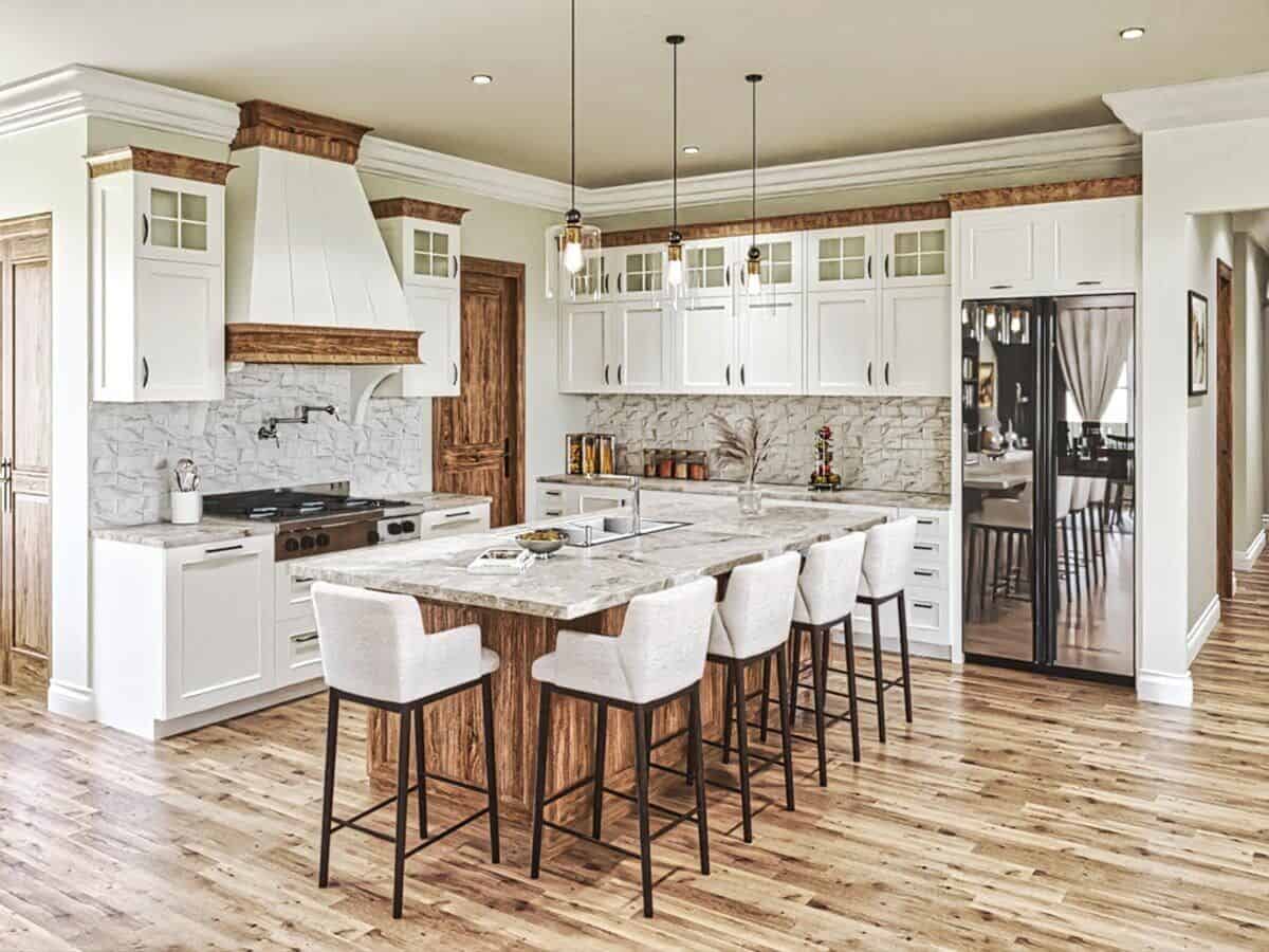 Kitchen with mirrored appliances, a breakfast island, and white cabinetry accented by natural wood trims.