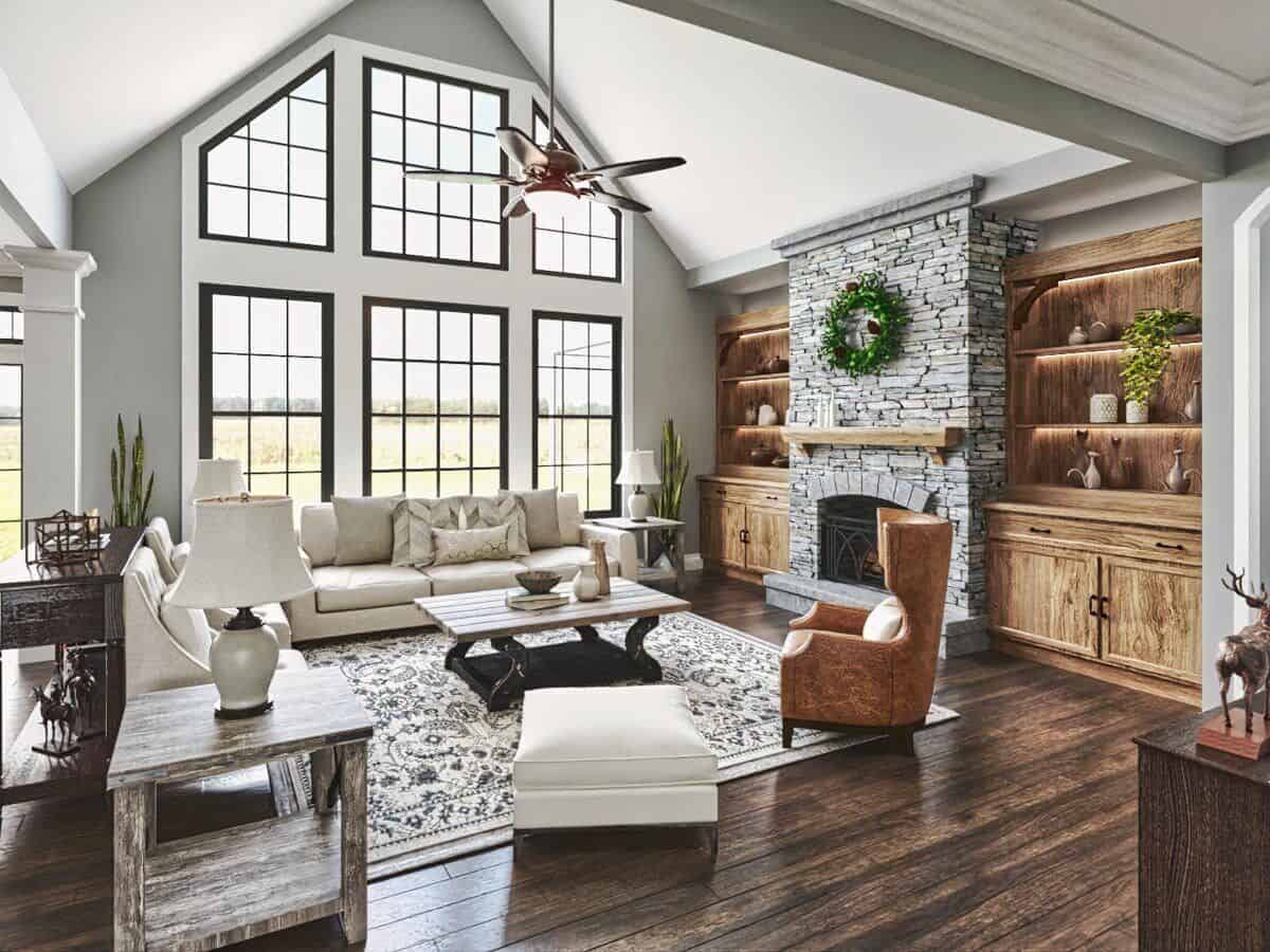 The living room features a cathedral ceiling, a stone fireplace, and massive windows that look out the backyard.