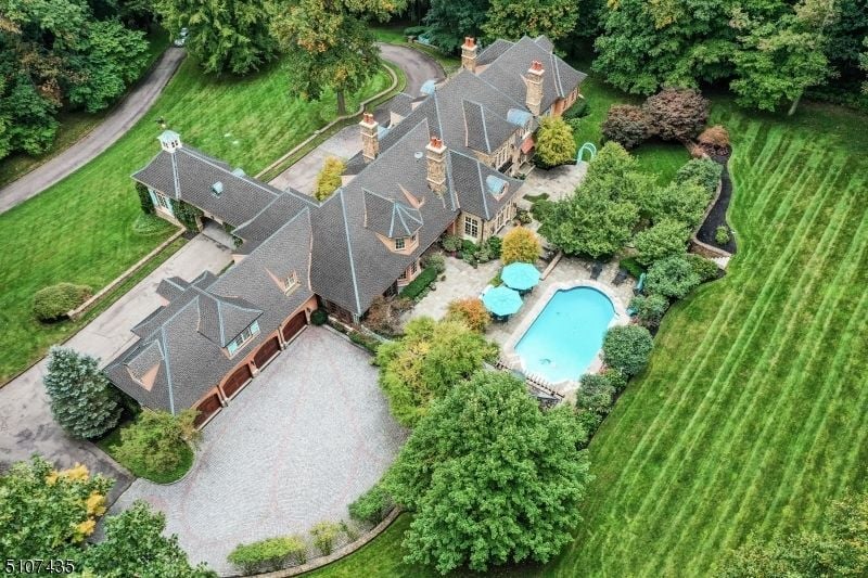 The surrounding is landscaped with lawn, and the surrounding trees cool the atmosphere of the house.