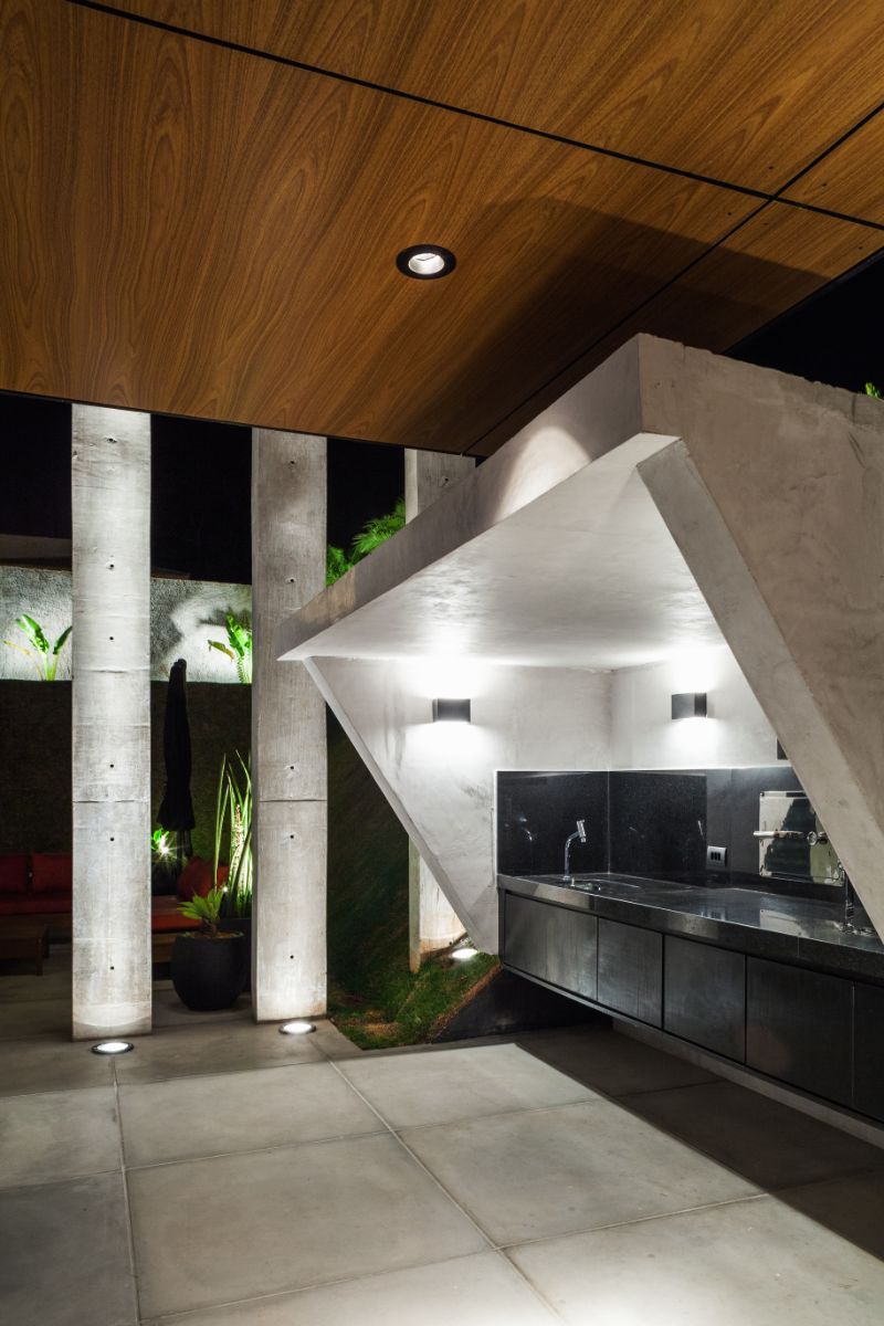 The concrete blocks and floating cabinets in the kitchen emphasize the modern design.
