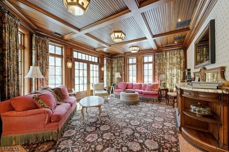 The living area features sofas and coffee tables.