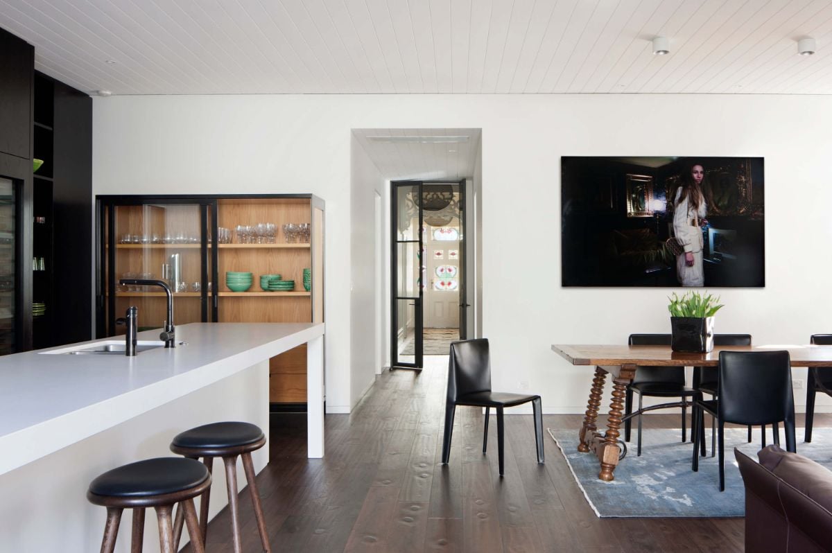 The dining area is designed with artwork and an area rug.