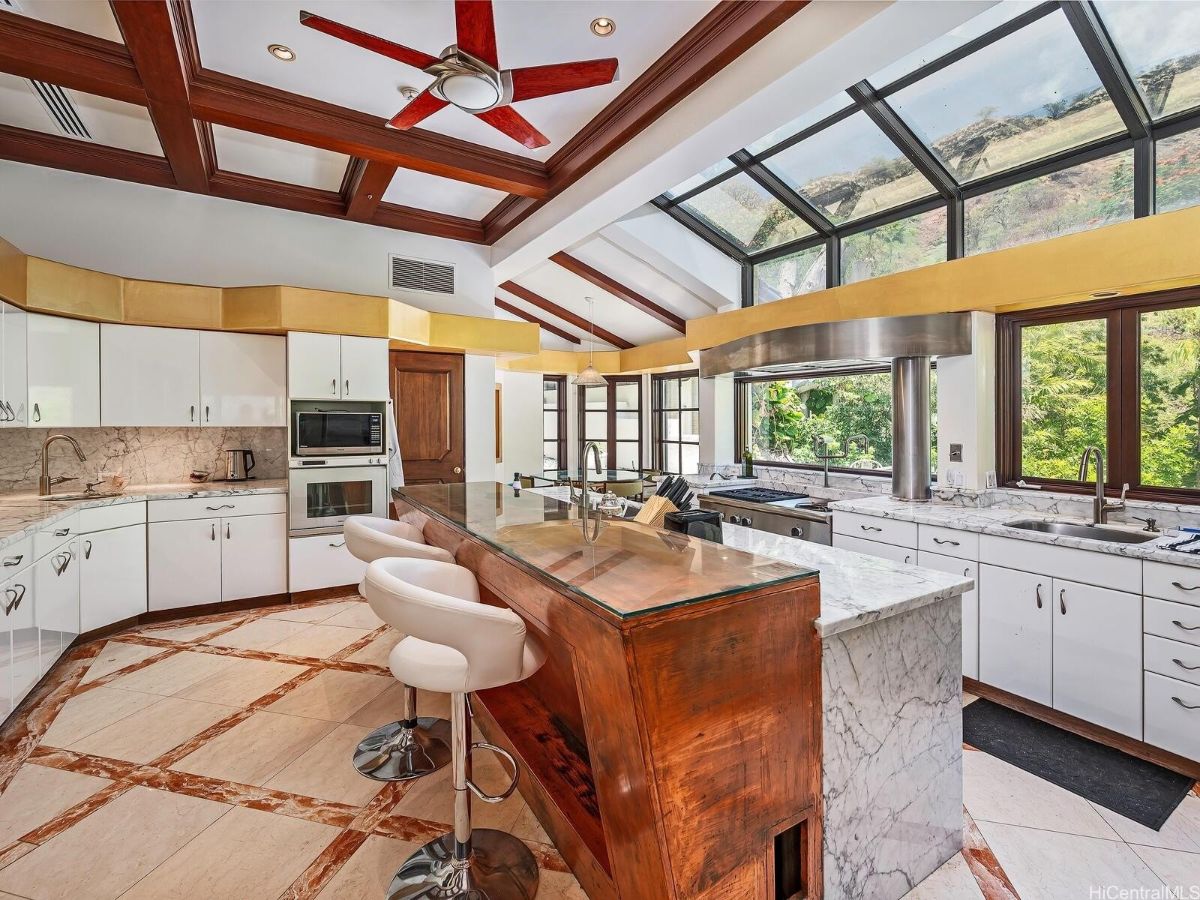 The kitchen features a bi-level kitchen island with a granite countertop.