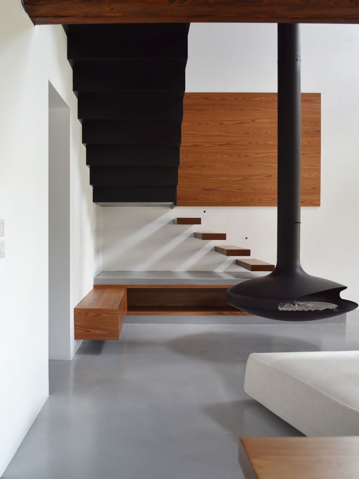 The house features floating staircases leading upstairs and floating benches.