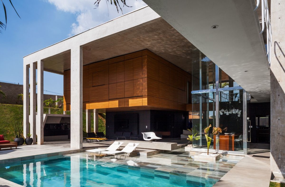A view of the turquoise pool from the intermediate spaces, which include the balcony, leisure, and living room areas.