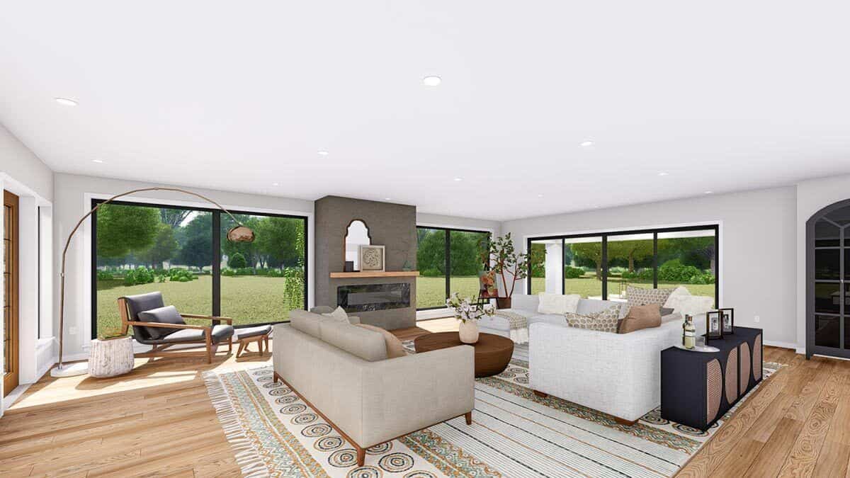 The living room is filled with modern sofas, a large fireplace, and a leather lounger complemented with a matching stool and arched floor lamp.