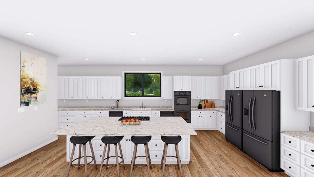 The kitchen offers tons of storage, slate appliances, and a center island equipped with a built-in cooktop.