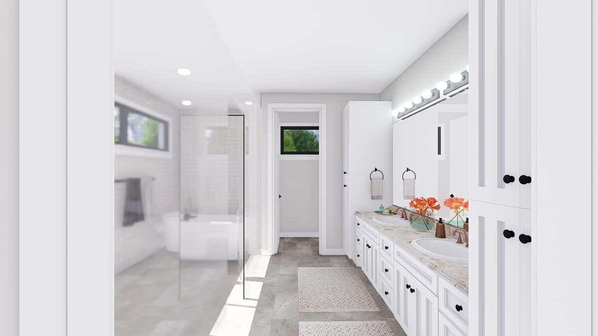 Primary bathroom with a dual sink vanity and a wet room with a freestanding tub.
