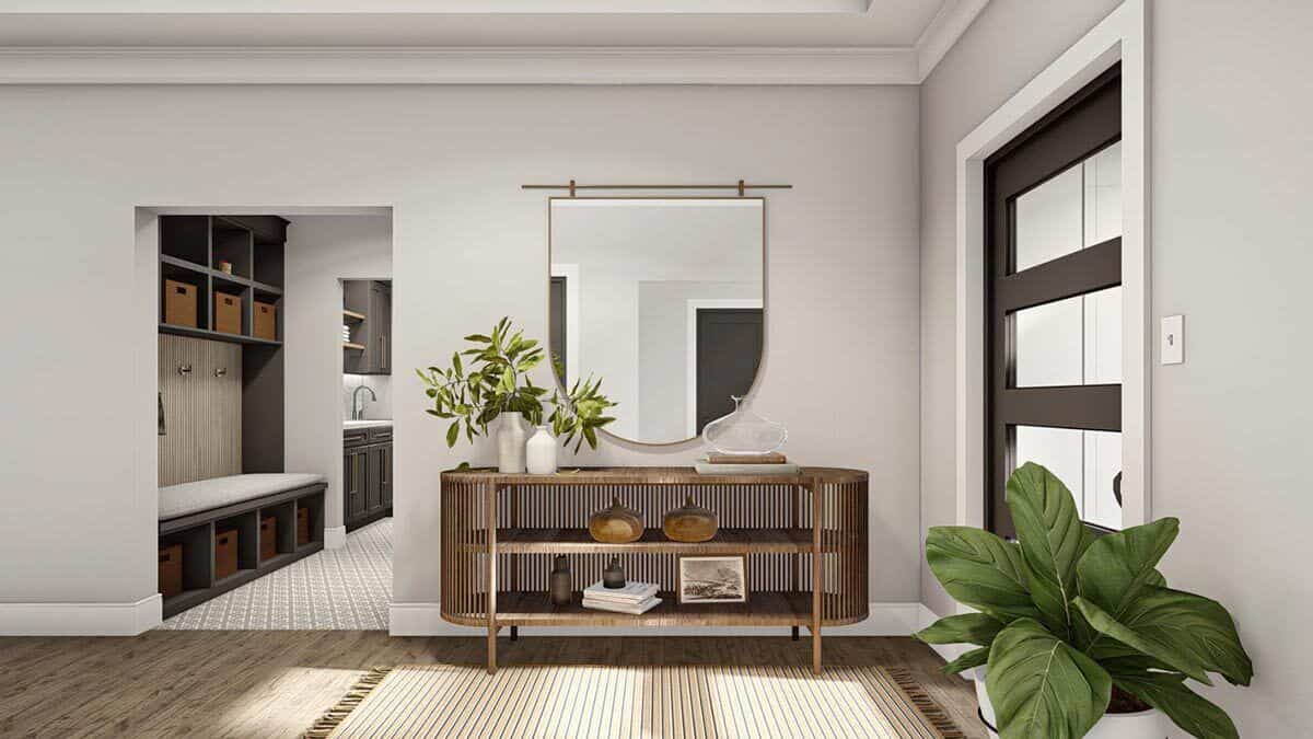An open doorway beside the console table leads to the mudroom.