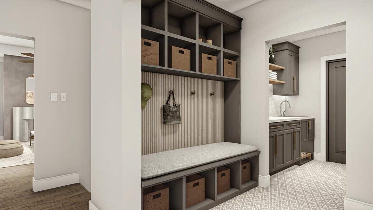 The mudroom has open shelves, a built-in bench, and an adjoining laundry room.