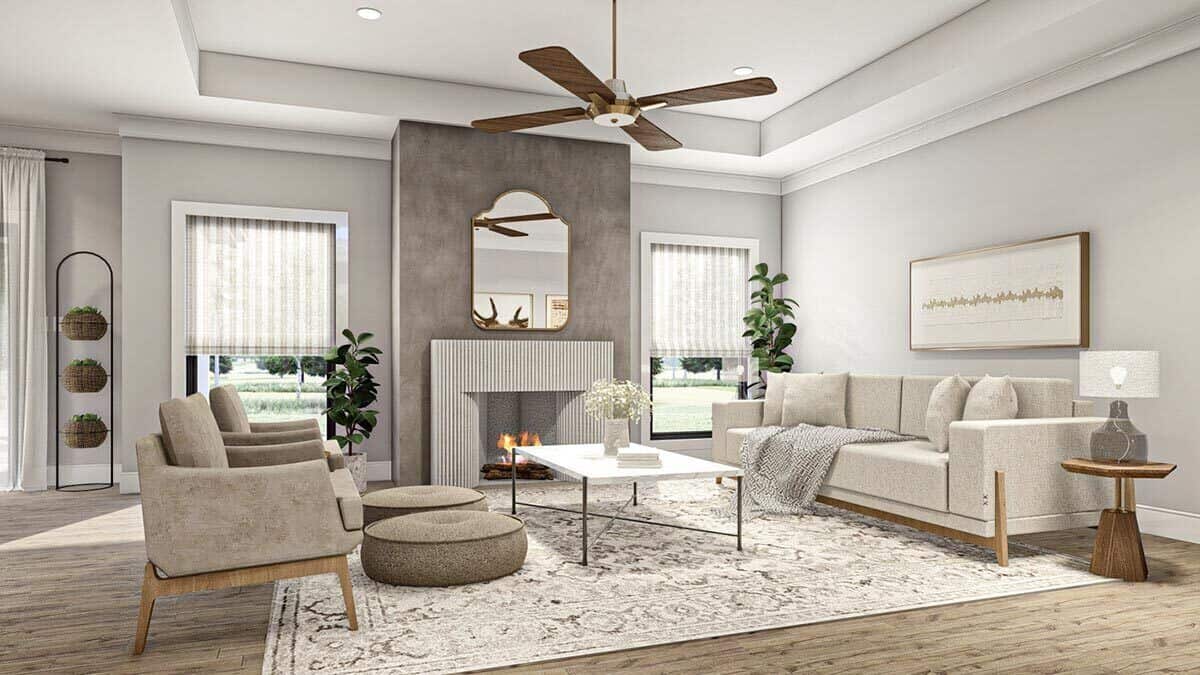 The living room features gray seats and a fireplace flanked by large windows.